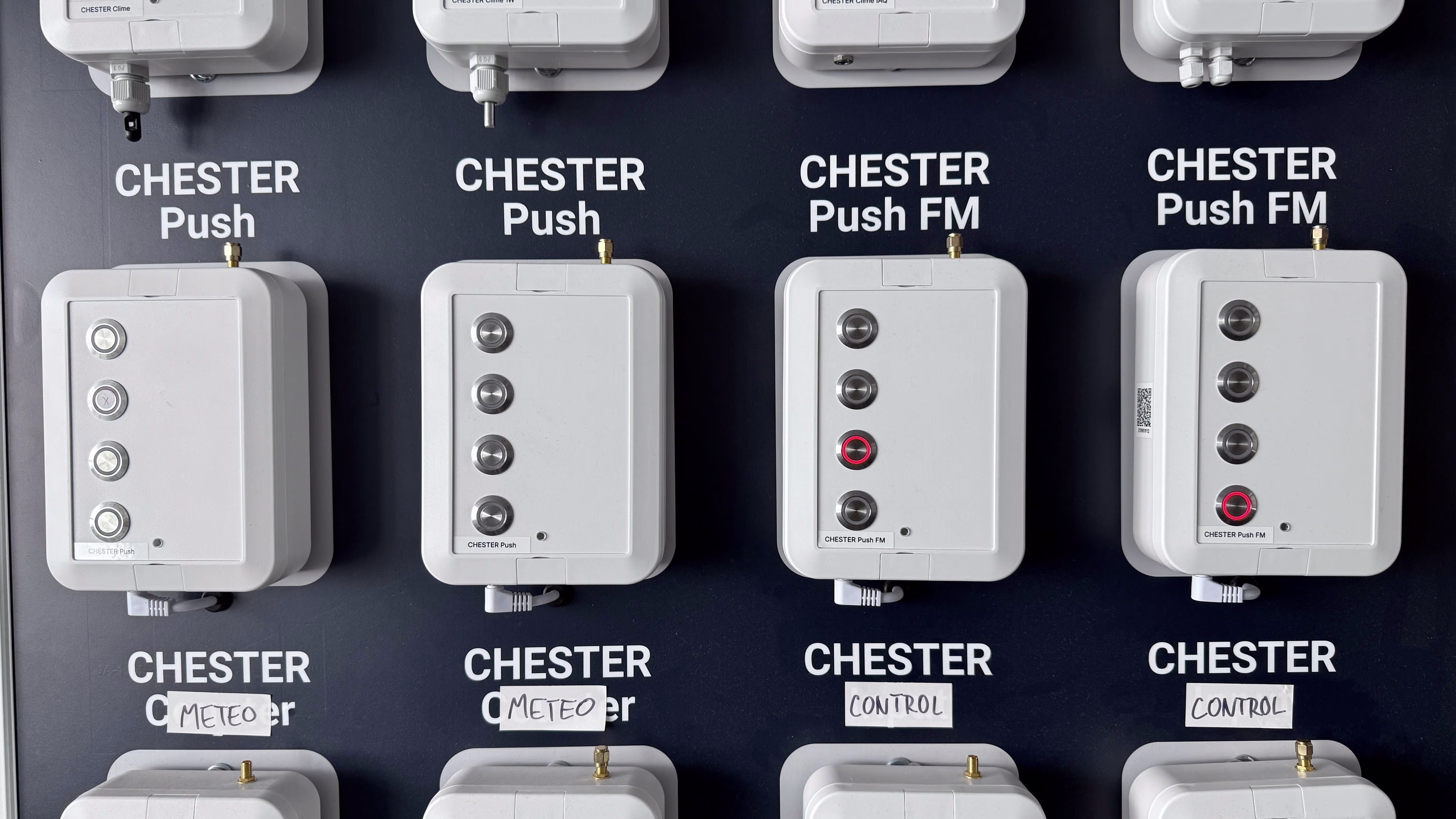 HARDWARIO test wall with multiple CHESTER device variants for firmware validation
